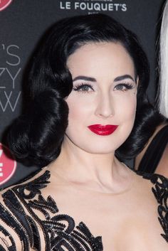 a woman with black hair and red lipstick