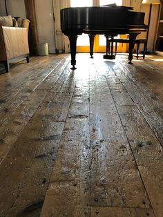 a piano sitting on top of a hard wood floor