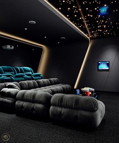 an empty theater with two recliners and a movie screen in the corner,