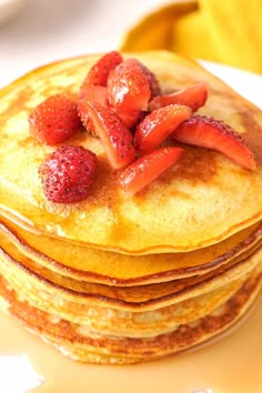 a stack of pancakes with strawberries on top