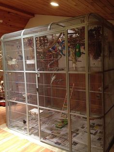 a large bird cage filled with lots of birds