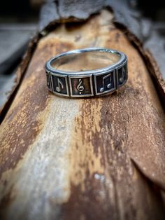 This rustic style Sterling Silver Music Ring is made by me in my shop in Billings, Montana. This ring features various musical symbols for musicians and music lovers alike. Please see the video for a 360 view of the ring.  These also make great gifts!  Made to order for both Men and Women Material: Solid .925 Sterling Silver Sizes: 5-14 Width: About 1/4 inch wide  Every ring I offer is designed and crafted by me and me only in my shop in Billings, Montana. I've been lucky enough to make hundreds of rings for people in my life and I'd love the opportunity to make yours!  Want to order this ring but you don't know your ring size? Message me and I'll help you :) I use the highest quality Sterling Silver in all of my rings. Sterling Silver is 92.5% Silver and 7.5% Copper to make a strong beaut Music Ring, Music Note Jewelry, Guitar Ring, Musical Symbols, Music Rings, Gifts For Music Lovers, Music Symbol, Gothic Music, Billings Montana