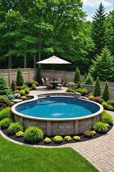 an outdoor pool surrounded by landscaping and trees