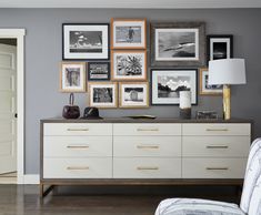 a living room filled with furniture and pictures on the wall