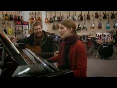 two people playing instruments in a music store