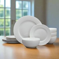 white dishes are stacked on top of each other