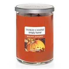 an orange jar filled with pumpkin candles