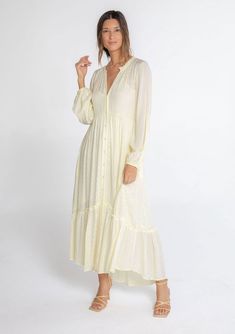 A classic bohemian maxi dress in a billowy silhouette, designed in textured checkered jacquard. This dreamy and versatile style features long voluminous sleeves, a delicate self-covered button front, and a ruffle-trimmed neckline. The tiered skirt adds shape and movement. Try this timeless style unbuttoned over denim! Checkered jacquard Relaxed, flowy fit Long voluminous sleeves Elastic wrist cuffs Maxi length Ruffle-trimmed tiered skirt Ruffle-trimmed round neckline Self-covered button front Si Flowy Maxi Dress Fall, Flowy Bohemian Dress, Shabbat Outfit, Long Sleeved Maxi Dress Fall, Maxi Dress Fall, Button Down Maxi Dress, Dusty Teal, Skirt Ruffle, Maxi Dresses Fall