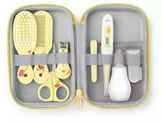 an open case with scissors, combs and other items in it on a white background