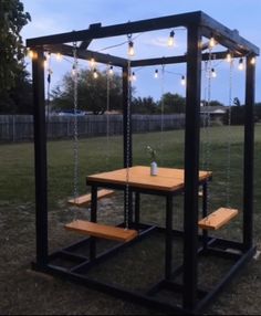 a picnic table with lights hanging from it