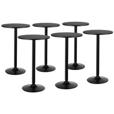 four black tables with round bases on each side, all in different sizes and shapes