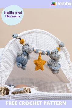 a crochet baby mobile with two teddy bears hanging from it