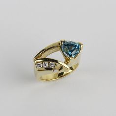 PURCHASE WITH CONFIDENCE Safe FREE Shipping 14 Day Returns Everything 100% Guaranteed! Find More Like This Description Payment Shipping Returns About Us Contact Us Custom 18k Yellow Gold, Blue Zircon, Diamond Womens Ring Size 6.25 Gender Women Material Gold Metal Purity 18k Main Stone Diamond, Zircon Quality Quality Guidelines New: Straight from the factory. Excellent: Previously-owned estate piece, unused or lightly used. May be tarnished because of age. May also be described as "unused" or "li Luxury Trillion Cut Jewelry With Tension Setting, Fine Jewelry Yellow Gold Trillion Cut Sapphire Ring, Fine Jewelry Trillion Cut Sapphire Ring With Accent Stones, Trillion Cut Yellow Gold Rings For Formal Occasions, 14k Gold Jewelry With Trillion Cut Accent Stones, Blue 14k Gold Jewelry With Tension Setting, Formal Rings With Accent Stones In Trillion Cut, Fine Jewelry Topaz Ring With Diamond Tension Setting, Yellow Gold Blue Topaz Rings With Brilliant Cut