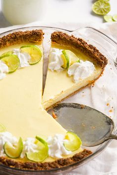 a pie with limes and whipped cream on top