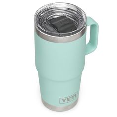 the yeti travel mug is made with stainless steel and has a teal color