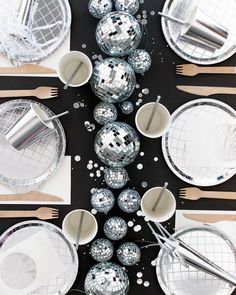 disco balls and silver plates on a black table