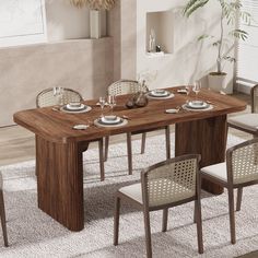 a dining table with four chairs and plates on it in the middle of a room