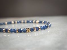 This gorgeous gemstone bracelet is made with high quality bright blue 3.3mm Sri Lankan Sapphire beads and is accented with 14k yellow gold filled Rondelle spacer beads scattered throughout. The gemstones are micro faceted and sparkle like glitter in the light. The micro faceting combined with the rich blue color or the beads makes them absolutely gorgeous in any light setting.  For the matching choker style necklace, please check my other listing: https://www.etsy.com/listing/1095955026/blue-sap Sapphire Beads, Luxury Blue Faceted Beads Bracelet, Choker Style Necklace, Blue Beaded Bracelets, Gold Bead Necklace, Diy Bracelets Easy, Gold Bead Bracelets, Crystal Beads Bracelet, Gemstone Beaded Bracelets