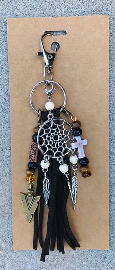 a keychain with beads and charms attached to it on a piece of paper