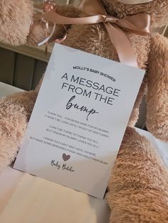 a teddy bear holding a message from the group