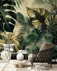 a living room with a chair, table and wallpaper that has tropical leaves on it