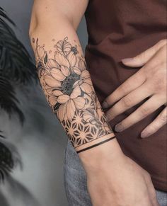 a person with a flower tattoo on their arm