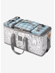 a blue and white suitcase with cartoon animals on the front, two straps at the bottom