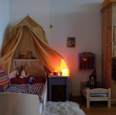 a child's bedroom with a canopy bed and teddy bears