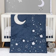 a baby crib bedding set with stars and moon