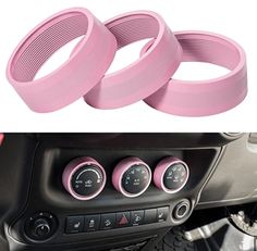 two pink gauges on the dashboard of a car and an image of a steering wheel