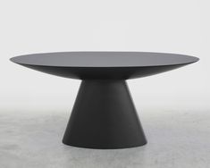 a round table with black top on a white background