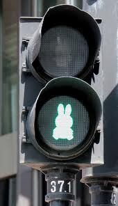 a traffic light with a bunny sticker on it