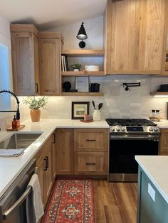 the kitchen is clean and ready for us to use it's new stove, sink, and dishwasher