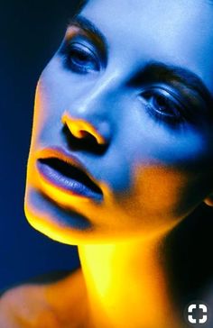 a woman with blue and yellow light on her face