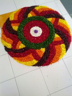 a multicolored flower arrangement on the floor