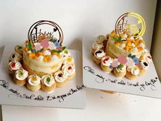 two cakes decorated with flowers and the words happy birthday on each one are sitting side by side