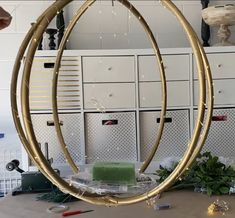 two large circular mirrors sitting on top of a wooden table next to white lockers