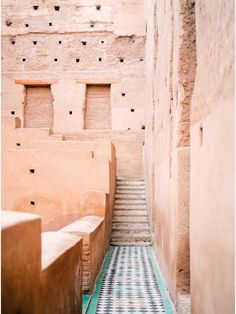 an alley way with steps leading up and down