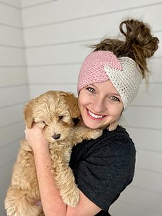 a woman holding a small dog in her arms