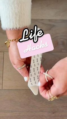 a woman holding onto a piece of paper with the words life hacks on it