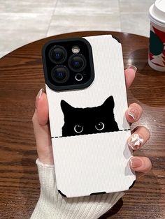 a person holding up a phone case with a cat on it