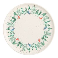 a white plate with green leaves and birds on it's rim, in the shape of a circle