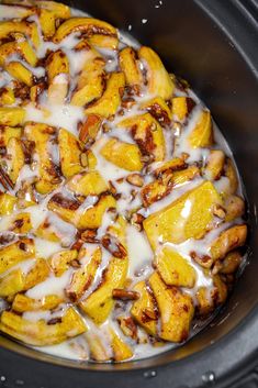 a crock pot filled with some kind of food that is covered in icing