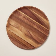 a round wooden plate on a white wall