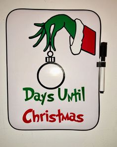 a white sign with the words days until christmas hanging from it's center piece