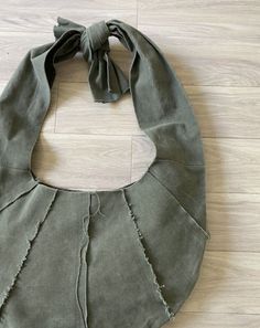 a green bag sitting on top of a wooden floor