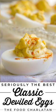 deviled eggs served in small white bowls with red sprinkles on top