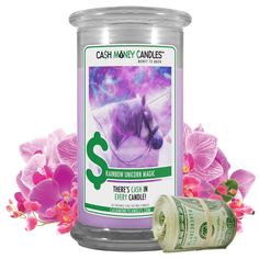 cash money candles are sitting next to pink flowers and purple orchids on a white background