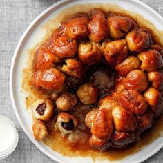 a white plate topped with meat covered in sauce