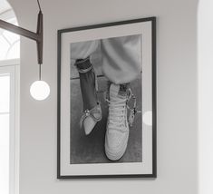 a black and white photo hanging on the wall